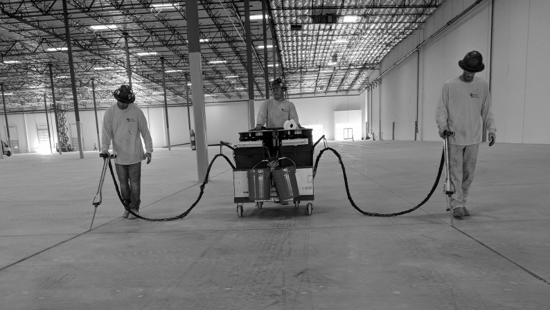 3 workers using HTS Super Pump in a large warehouse